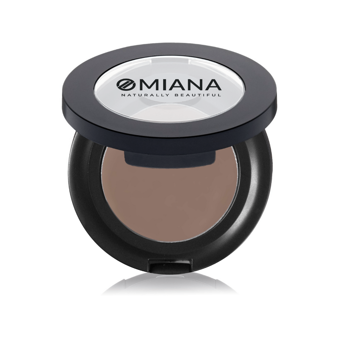 Compact powder vegan mineral brow cream in a black case with Omiana branding on a white background